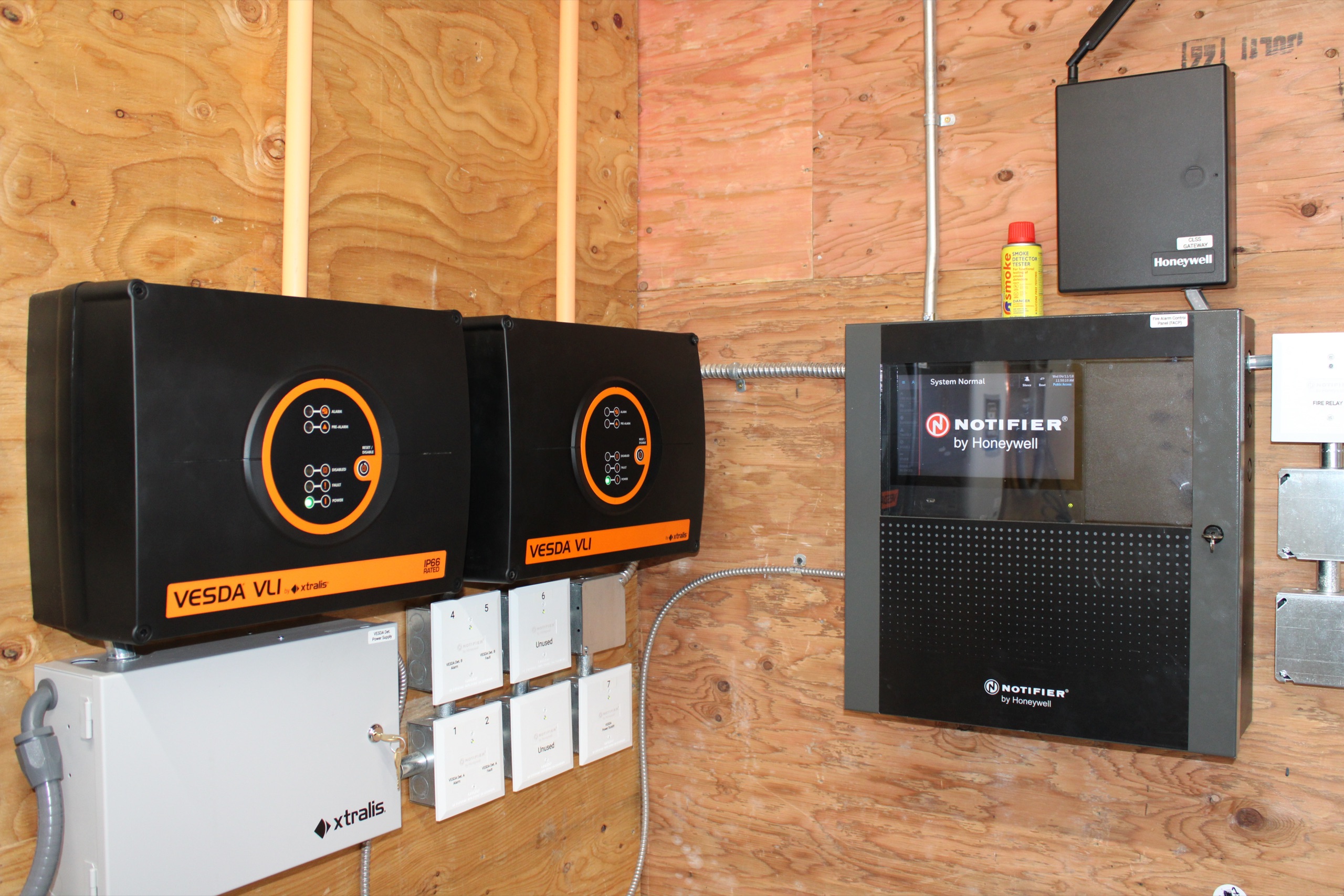 Fire alarm and releasing control panels mounted on a wall