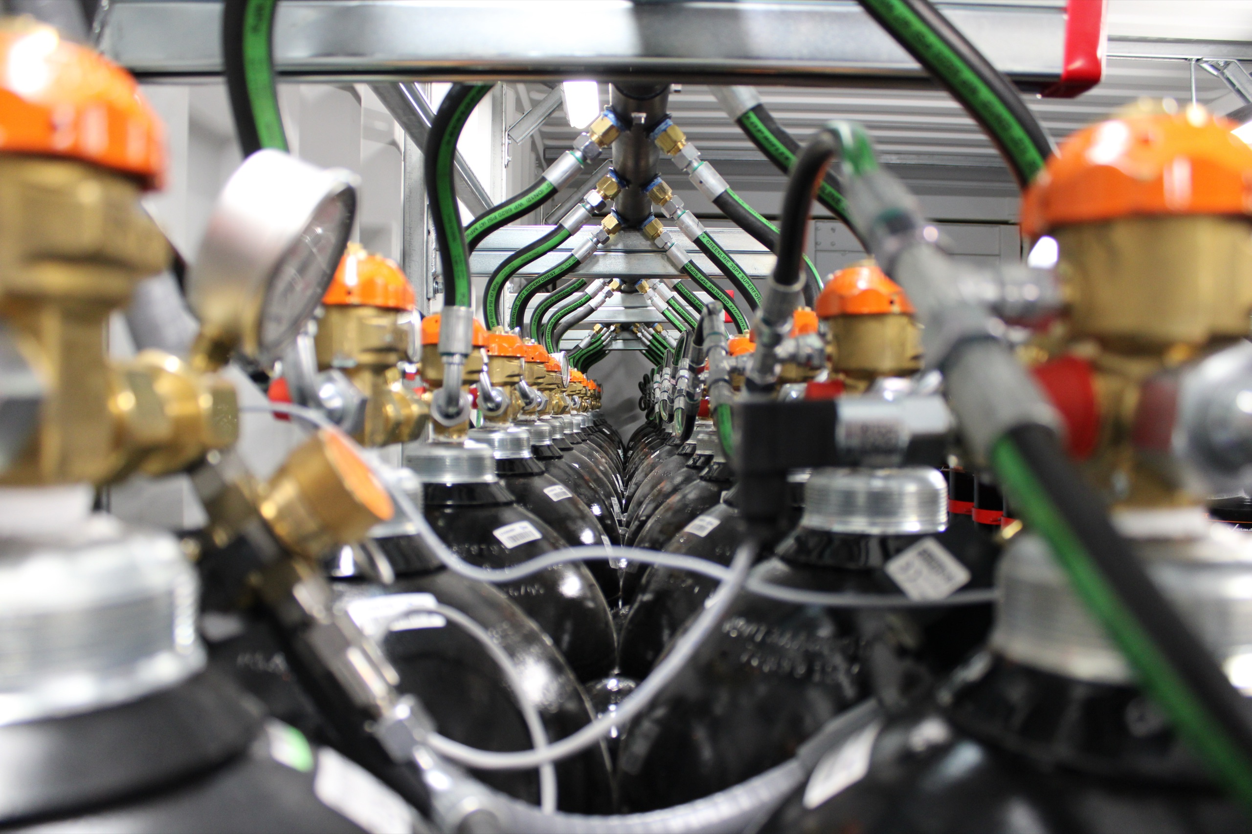 Close view of suppression cylinder valves and green hoses